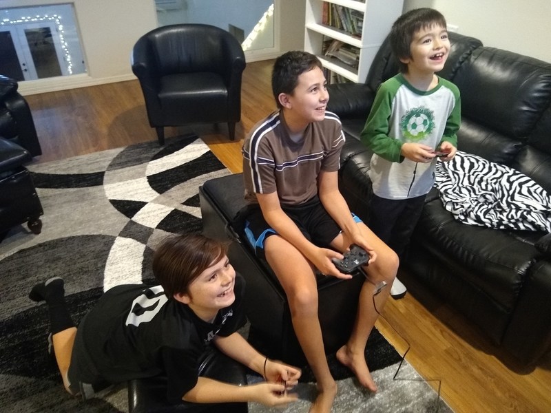 Three boys playing Super Mario Maker 2.