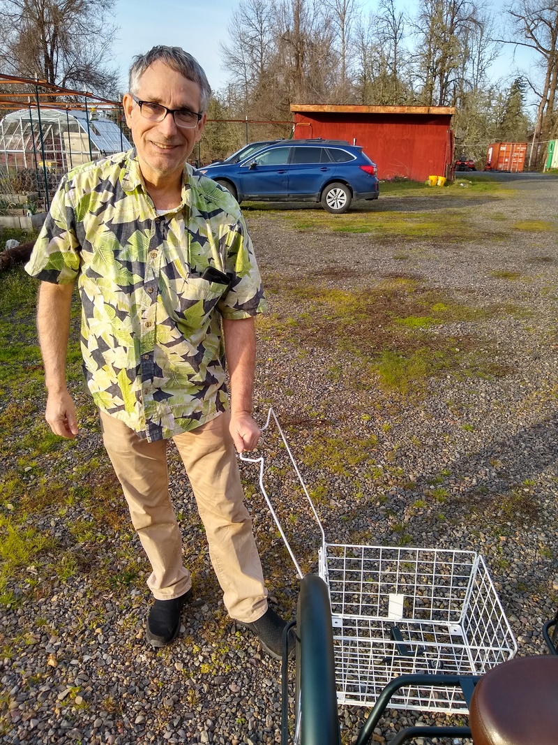 Jim showing how the basket turns into a shopping cart.