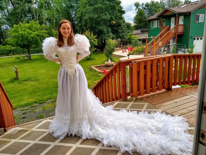 Tia humored grandma by trying in a wedding dress that she had also tried in years before.