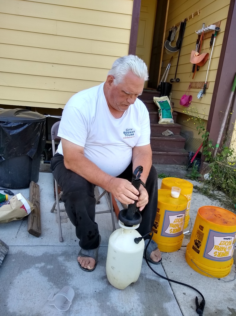Don is making up jugs of weed killer for Lois who got tired of looking at weeds after three years of not using chemicals.