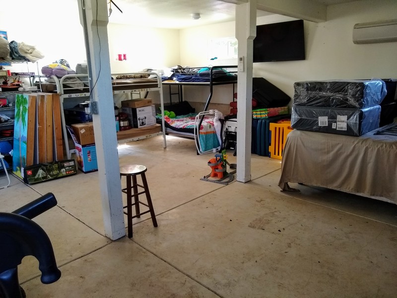 Ghe garage from another view. It did look slightly better but then I loaded up s bunk bed to move the appliances to a container. I also pulled futons on the bed which would probably go on the floor or out into a tent during a reunion.