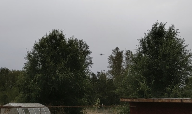 Here is one of the helicopters carrying a water bag to the fire. You can see how close it is to our house.
