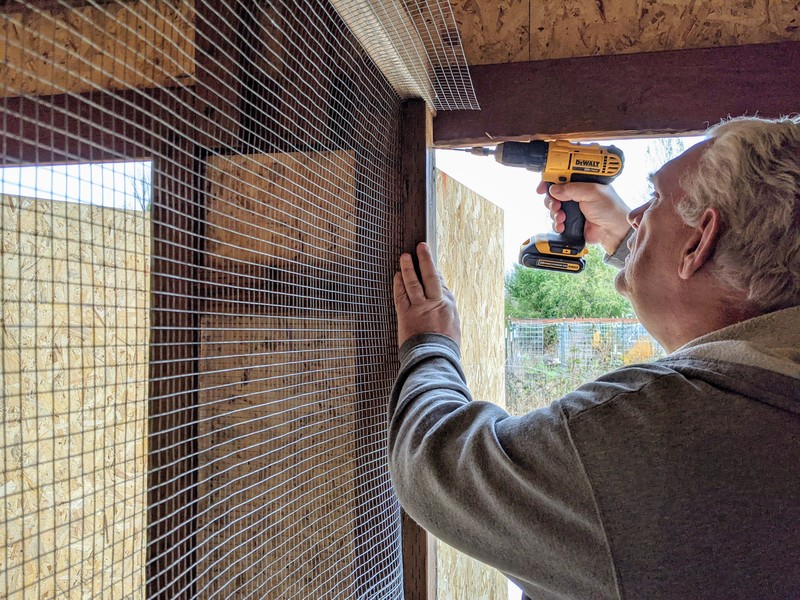 Don installs the 2x4 that had fencing mesh attached to it.
