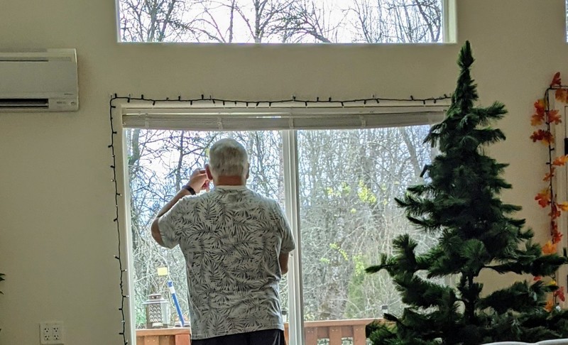 Don marking the window where there bird feeders should go.