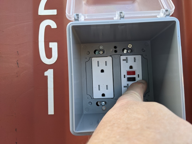 CCon: Don points to the green light showing the GFCI outlet is active.