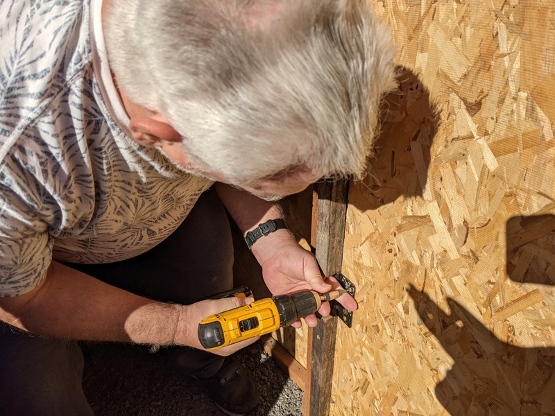 Don repairing the Chickery door.