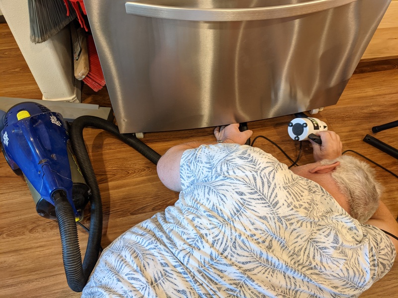 Don cleans Ruby's condenser coils.