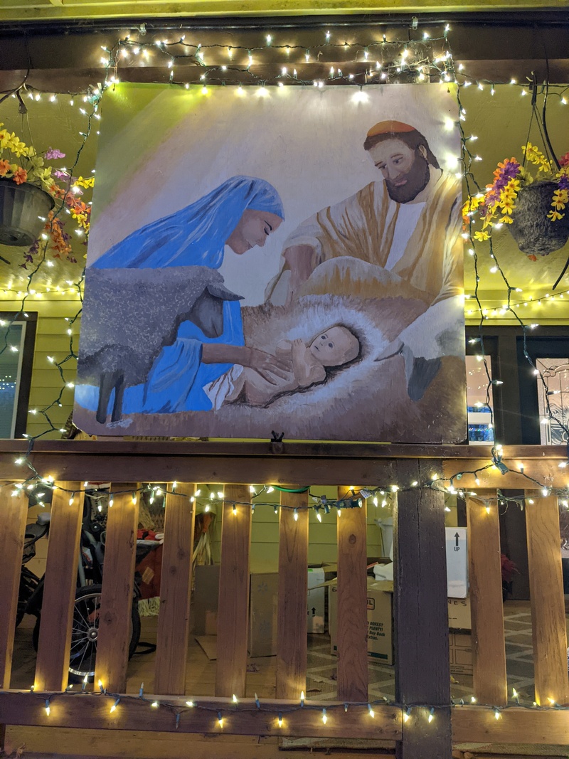 Lois's Nativity Artwork is hanging on our front porch.