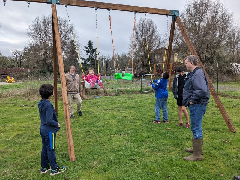 Fei Fei gives the swing set its first use.