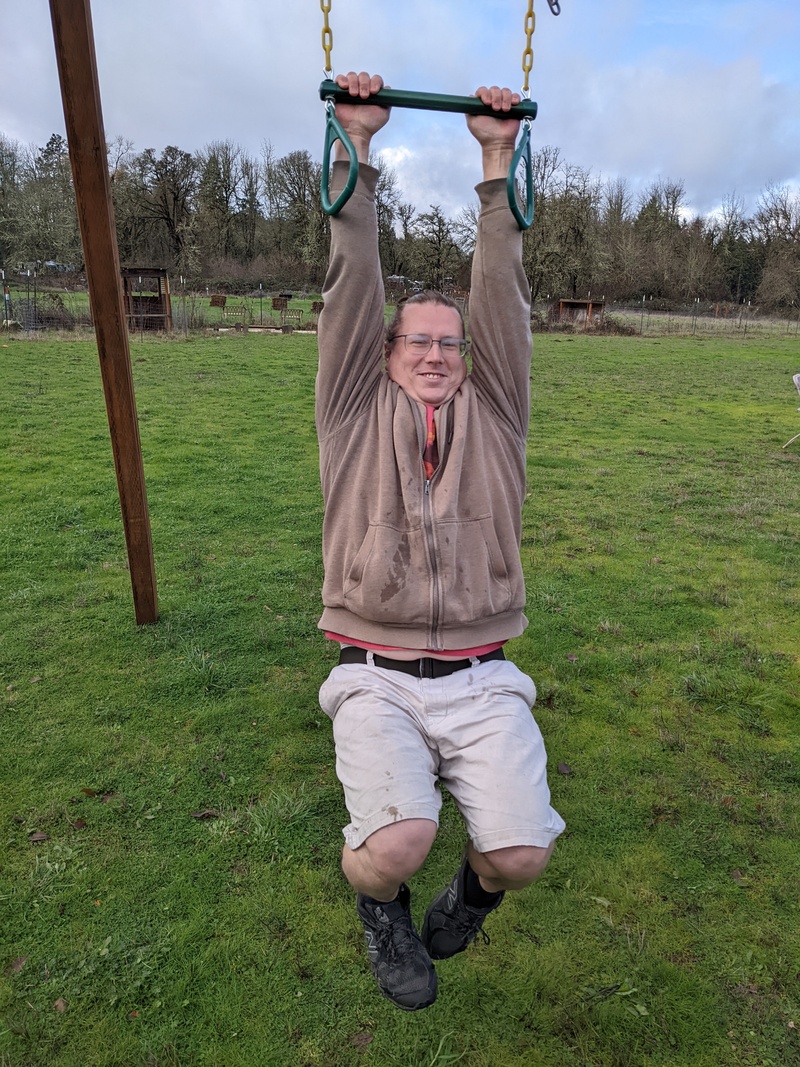 Ben trying to swing on a low trapeze bar