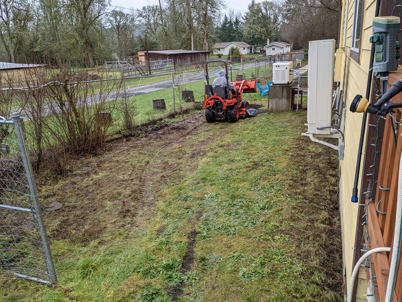 Don is putting gravel in the East garden.