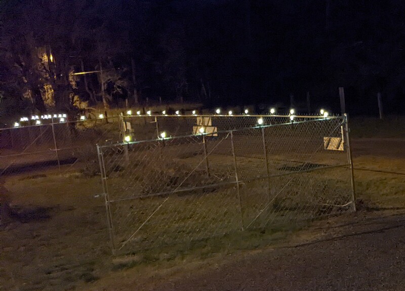 Stick lights on the fence between the two gates.