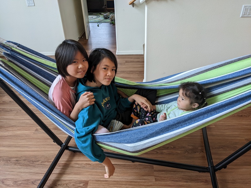Three girls in a hammock.