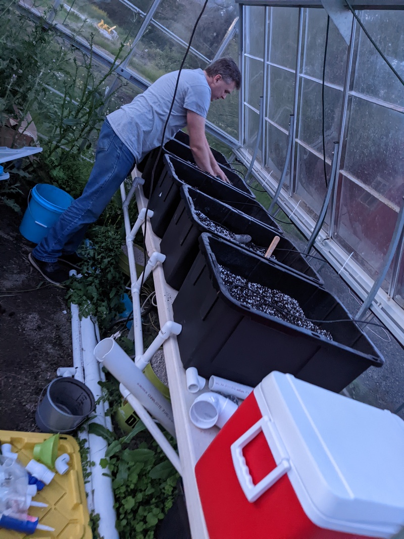 Joseph working in the greenhouse dirt.