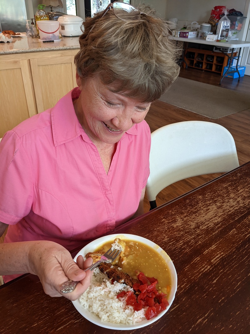 Laura eating curry and pork cutlet.