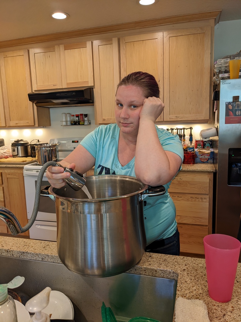 Does Stacia look bored filling the pan with water to cook pasta?