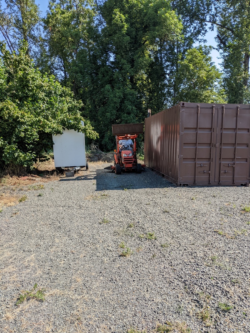 Don hauling branches to the compost with the tractor.