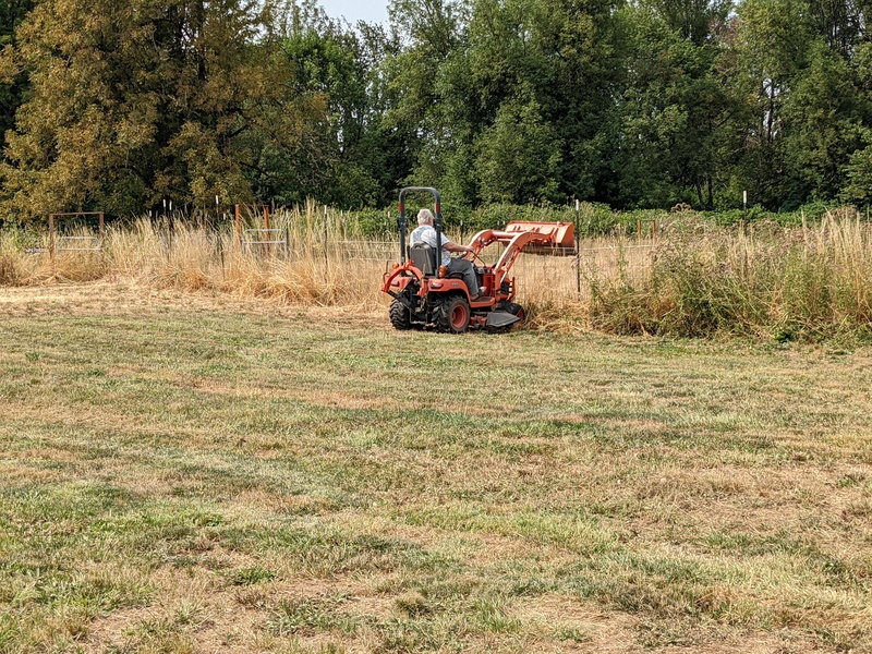 Don moving bales of straw.