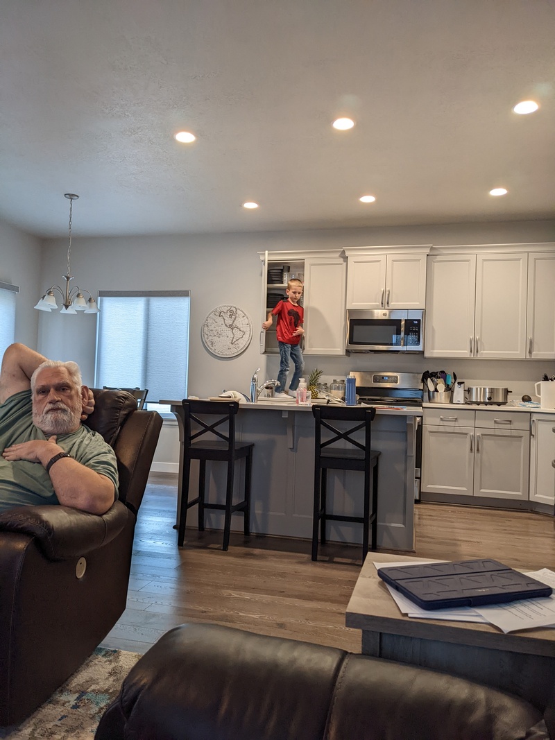 Austin demonstrates how to put dishes away.