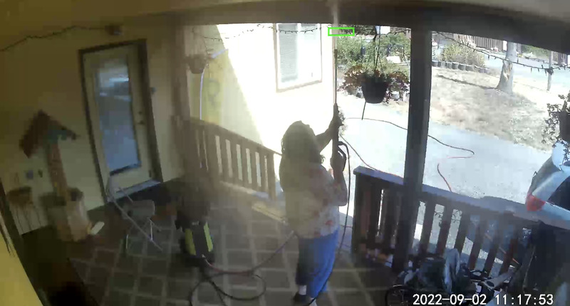 Lois powerwashing the front deck.