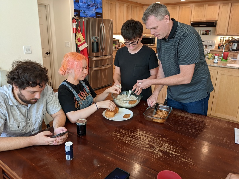 Joseph family stuffing rice into pockets for dinner.