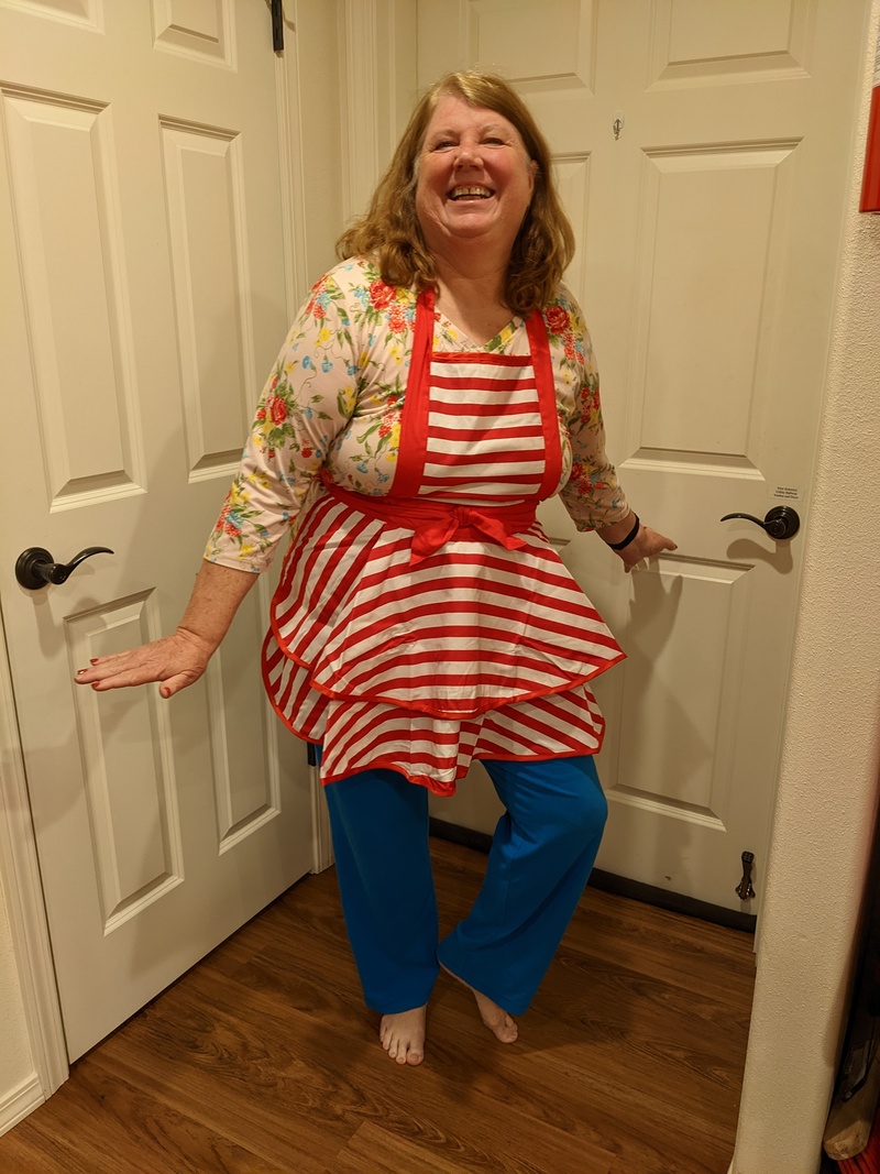 Cute girl showing off her new Mrs Claus apron.