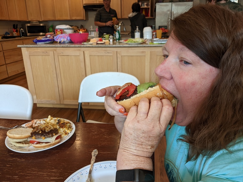 Lois eating a hamburger in a keto bun.