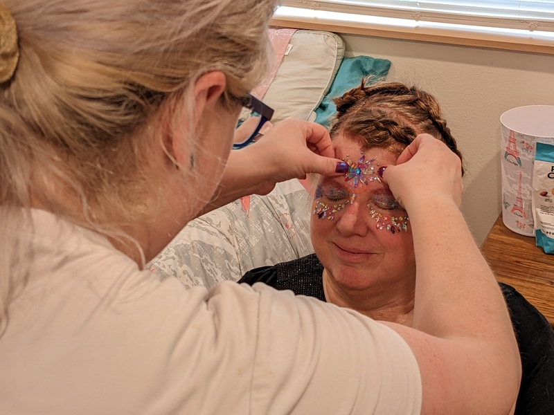 applying gems to the face.