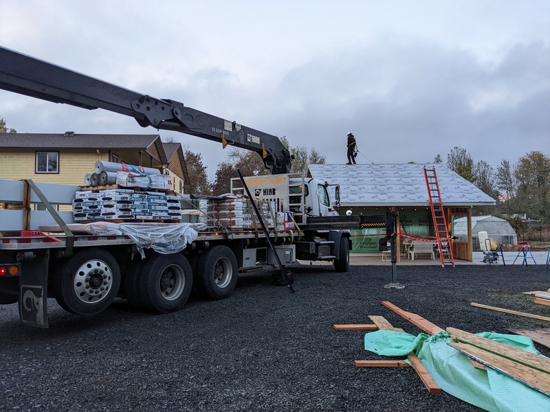 Unloading roofing material.