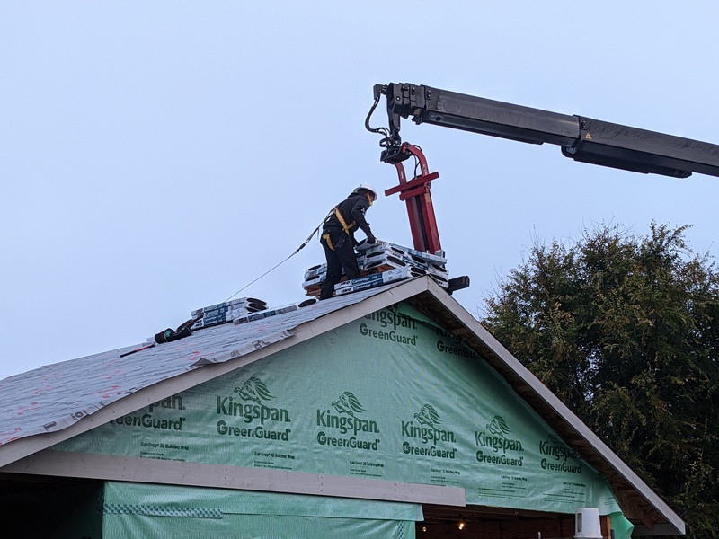 Unloading roofing materials.