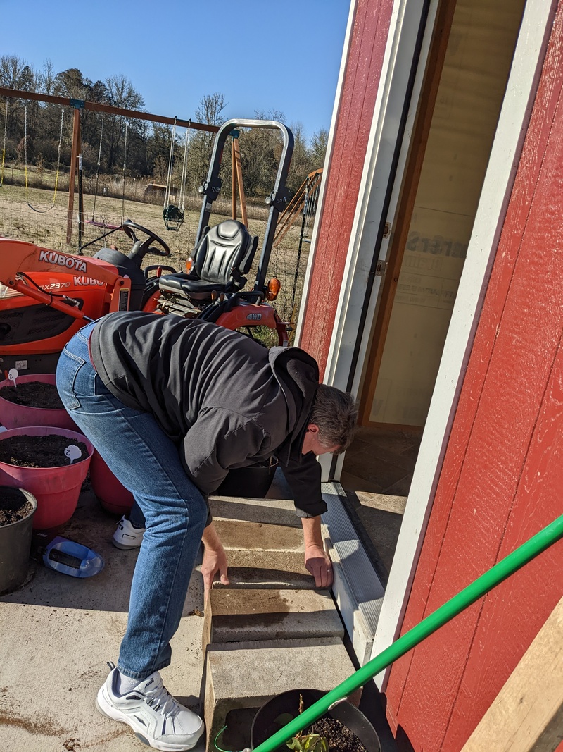 Joseph making a step out of concrete blocks.