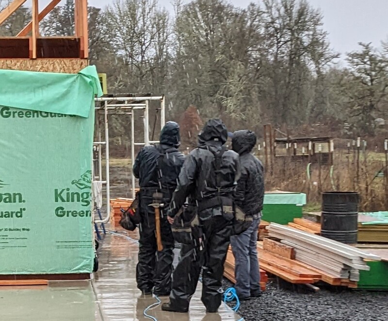 Workers planning in the rain.