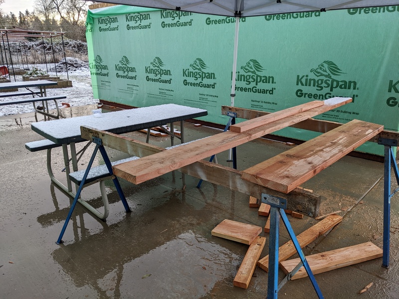 Snow on table and wood.