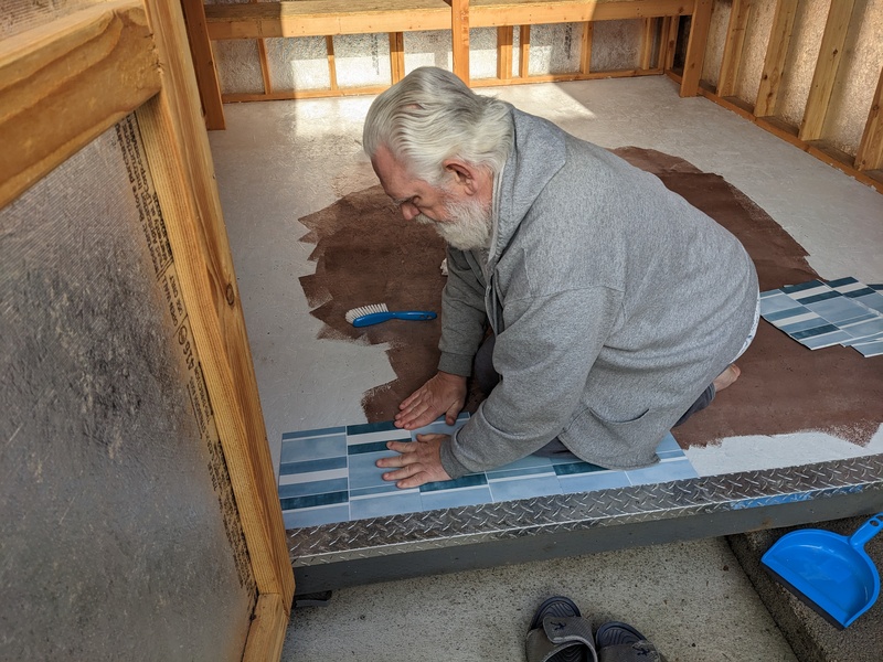 Don laying 12" tiles in B6