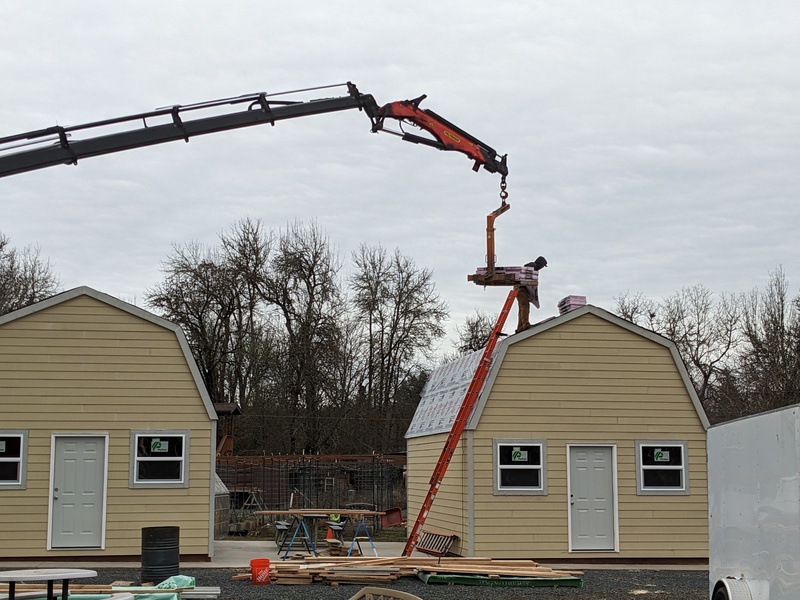 B3 Loading the roofing materials.