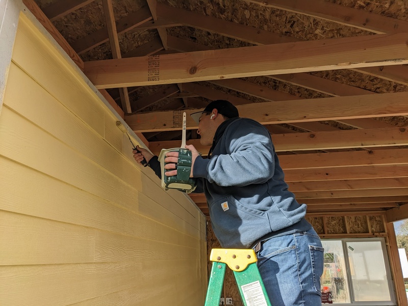 Jesse paints the sheltered wall in the Bower.