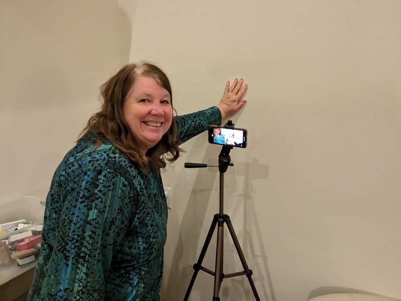 Lois shows off her piano video recording apparatus.