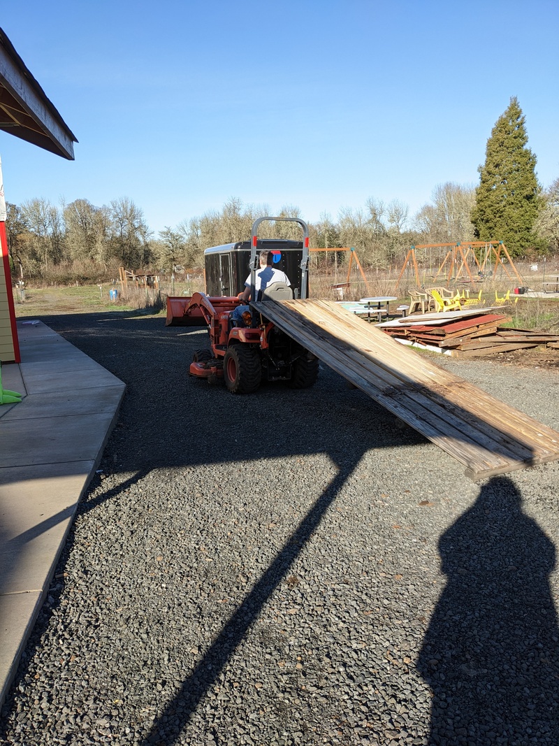 Joseph hauls a pallet back to his construction site in the new rose garden area.