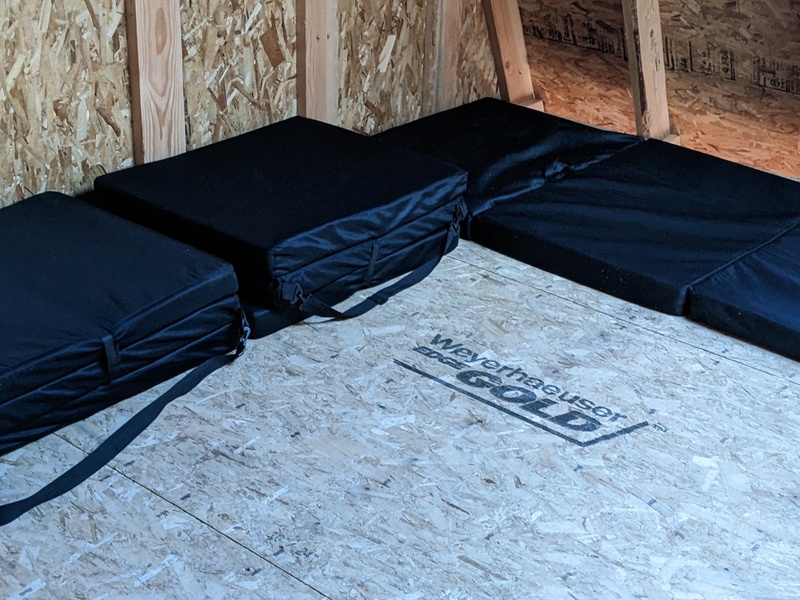 Folding mats in the loft of B2.