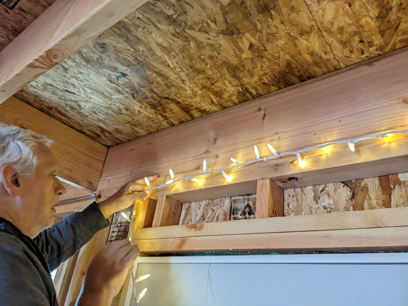 Don hanging lights in the Germany cabin.