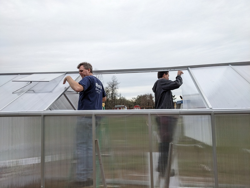 Joseph and Alex putting in roofing panels.