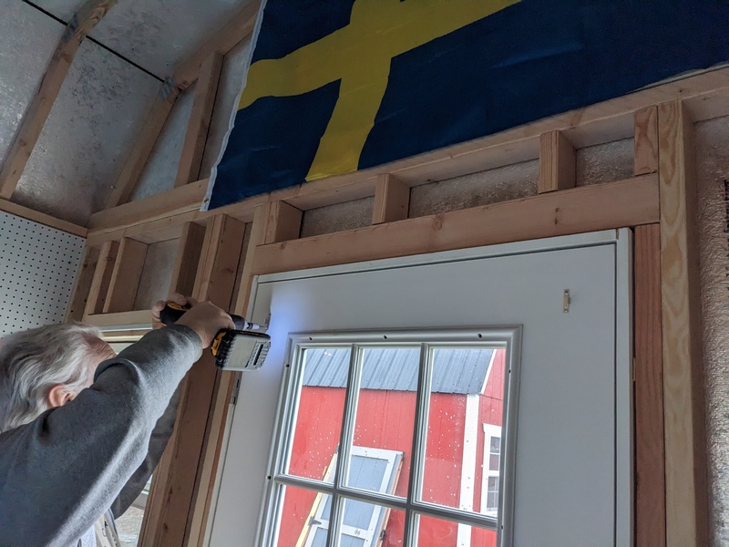 B5 Don putting up a curtain rod in Sweden. We put up three curtain rods today and one magnetic one.