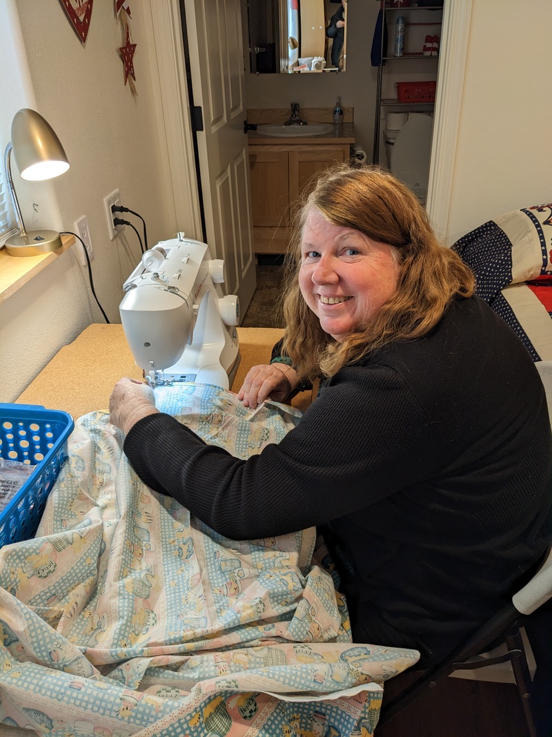 Lois sewing curtains.