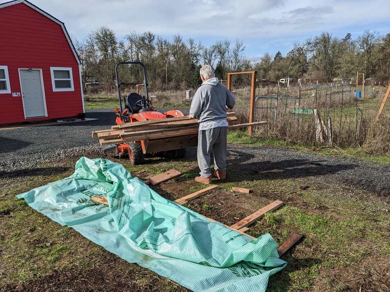 Moving the good wood pile out of Firepit Garden.