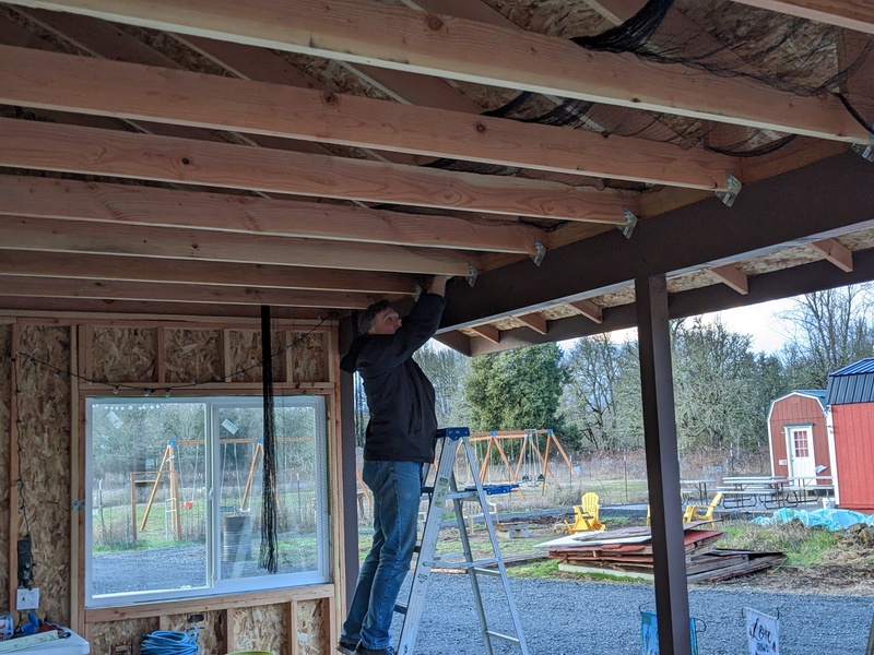 Joseph putting up the netting in The Bower. It's a big step in keeping bird poop out.