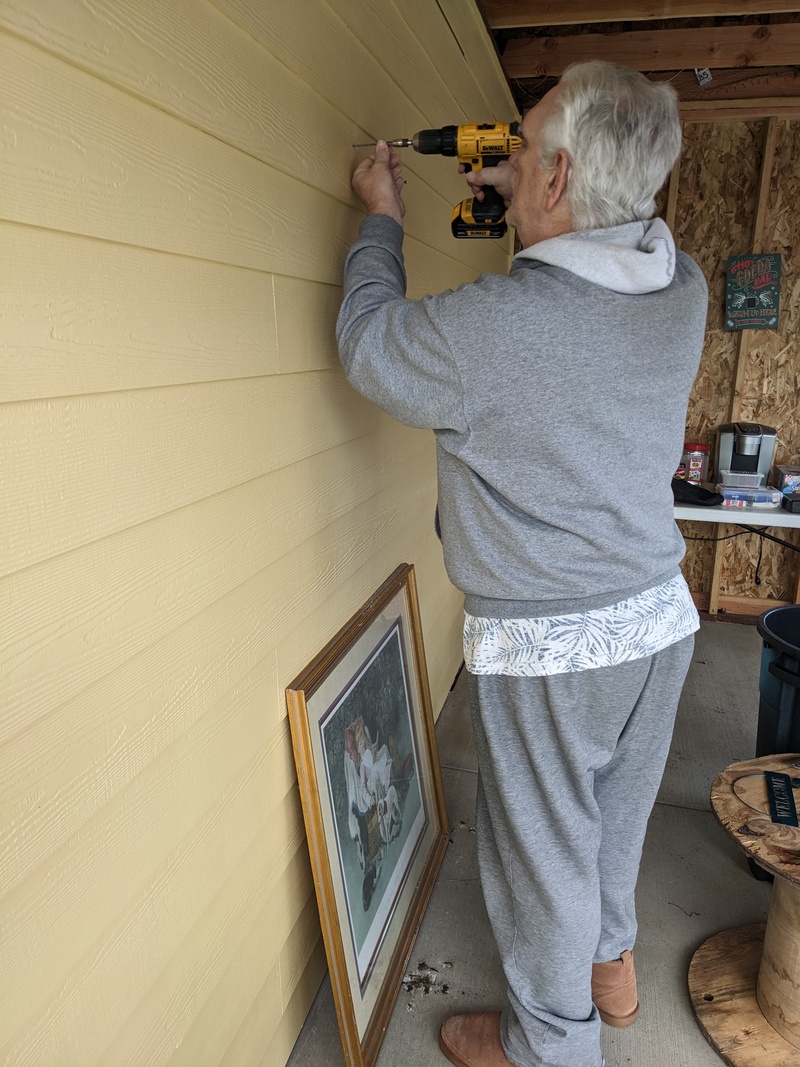 Don adds screws to hold Lois's decorations.