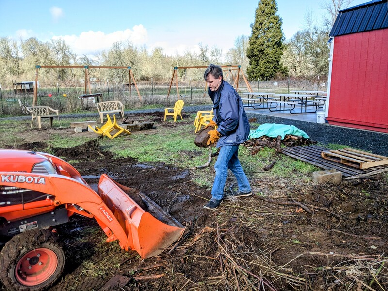 Joseph doing Firepit Garden cleanup.