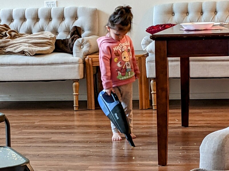 Fei Fei vacuuming the floor.