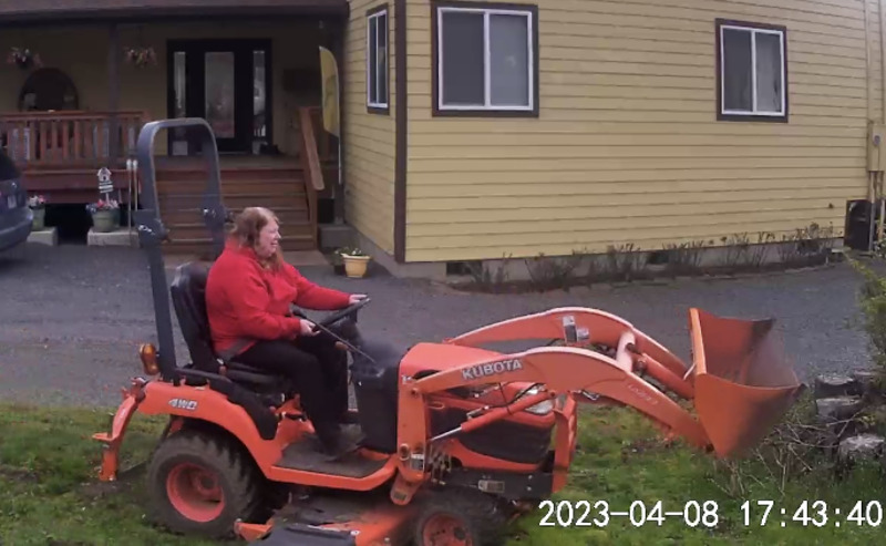 Lois trying to get some mowing done between days and days of rain.