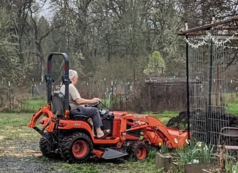 Don transferred dirt to the firepit flower garden area.